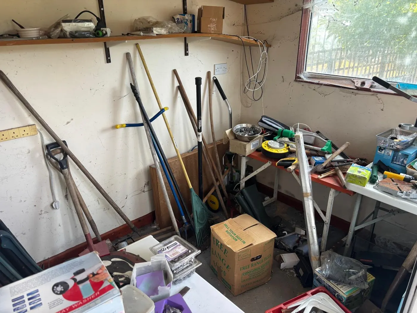 Garden shed clearance with gardening tools, ladders and boxes