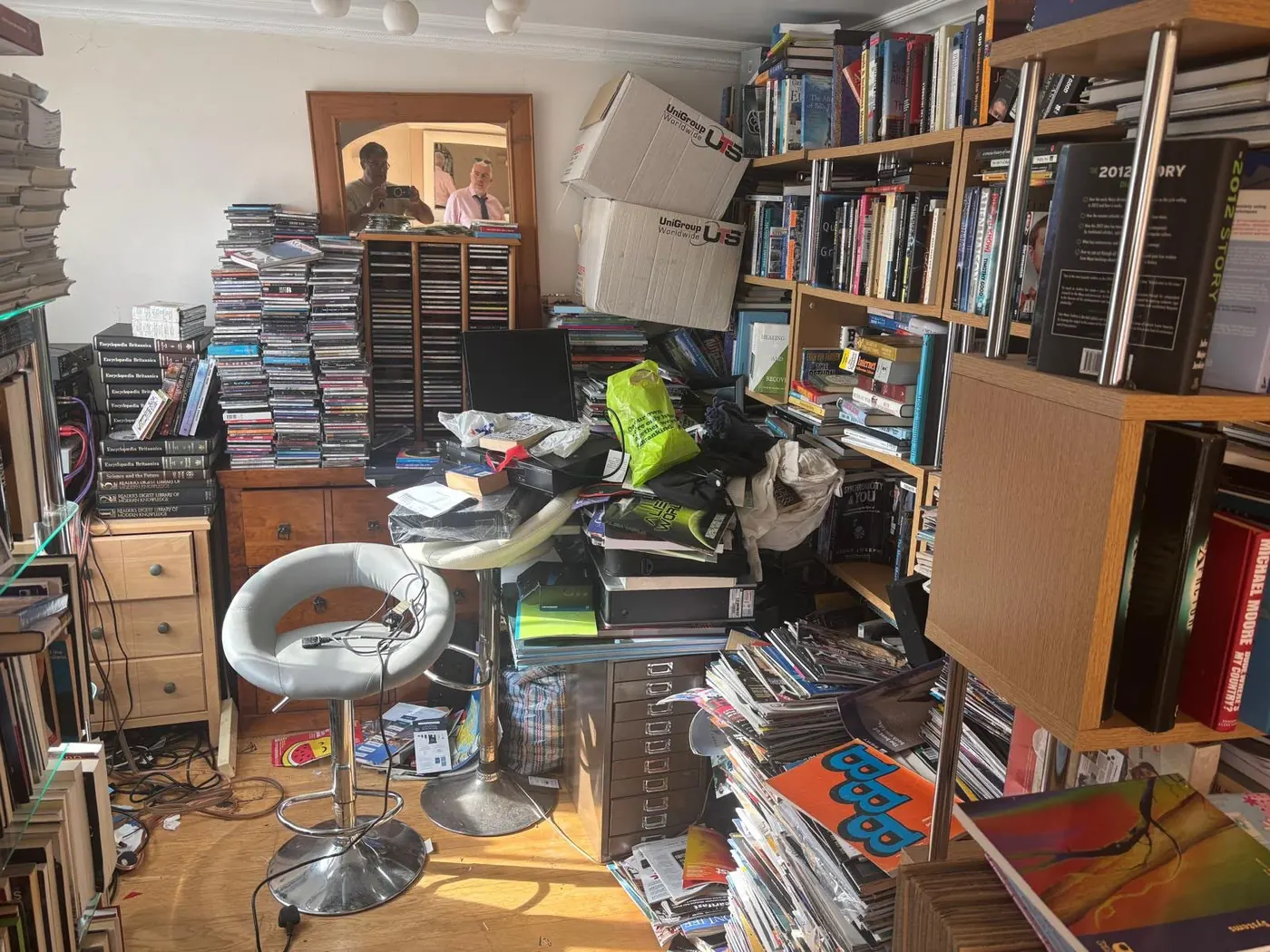 Densely packed room of books, CDs and boxes typical of an excessive clutter clearance