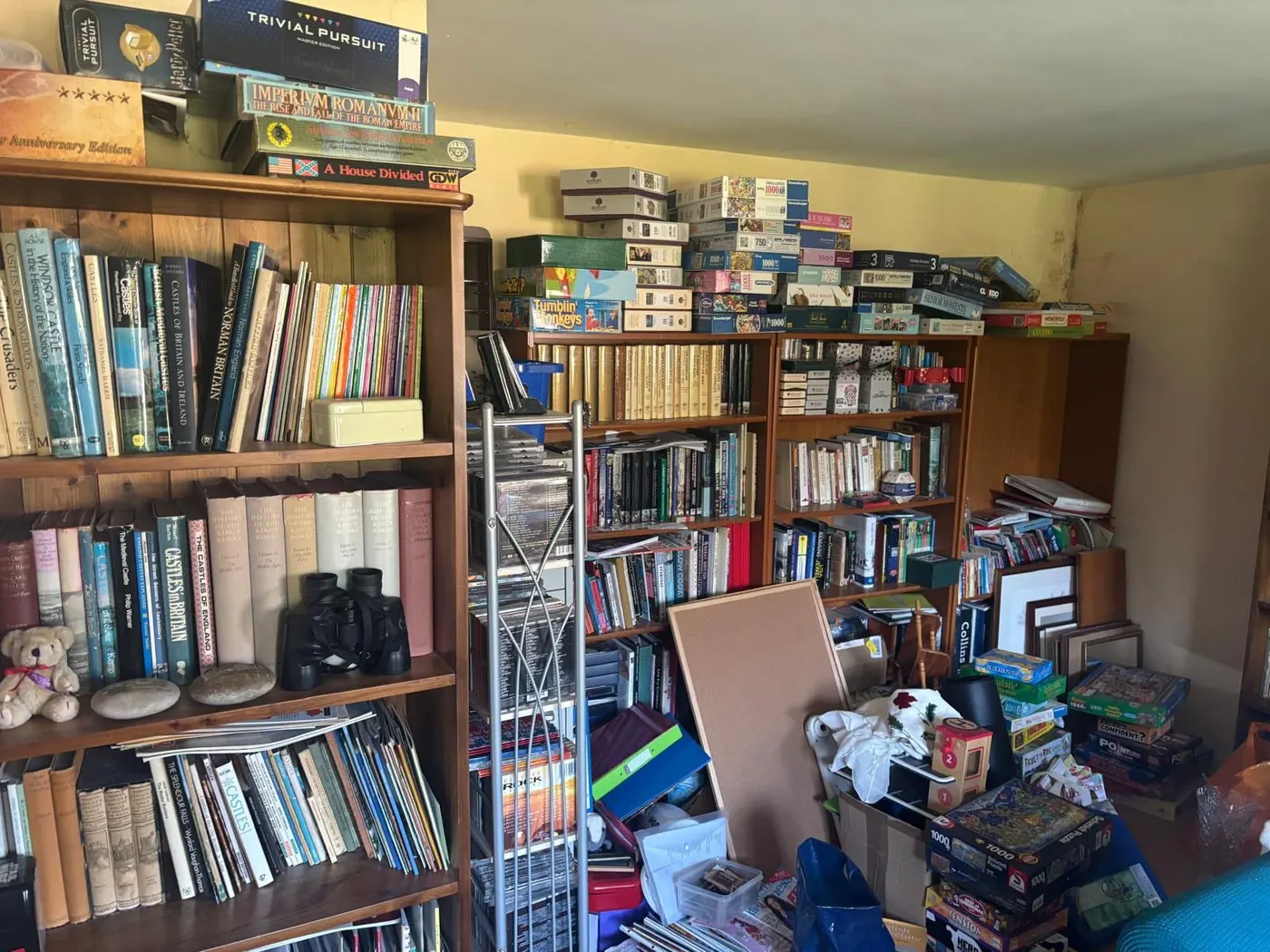 Hoarding clearance of a room packed with books, records and stacked games