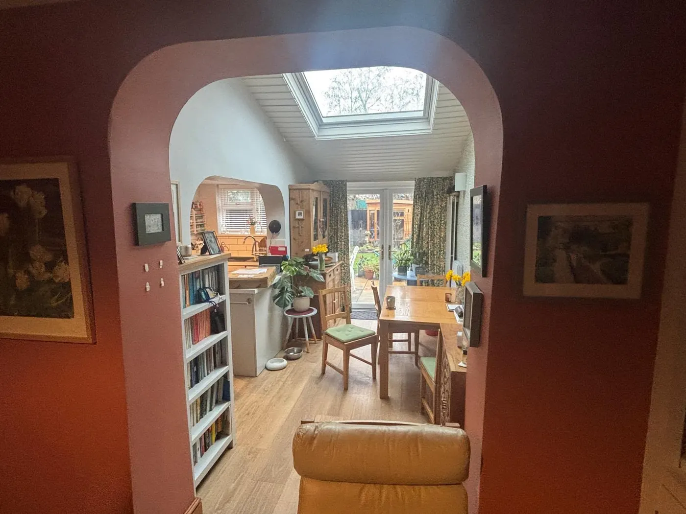 Furnished dining and living space viewed through an archway before a full property clearance