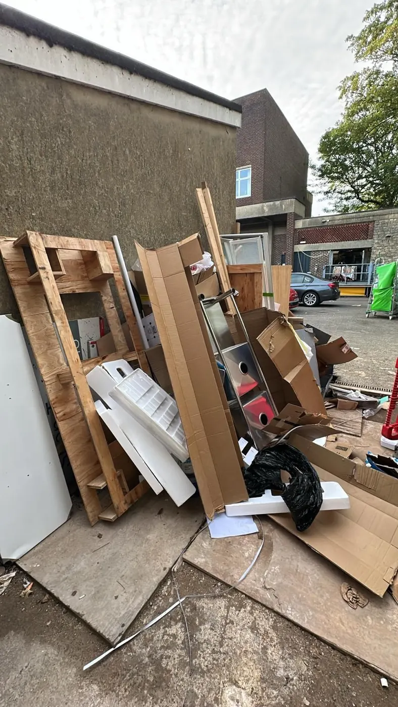 Timber, cardboard and bulky waste stacked for removal outside a property in Oxfordshire