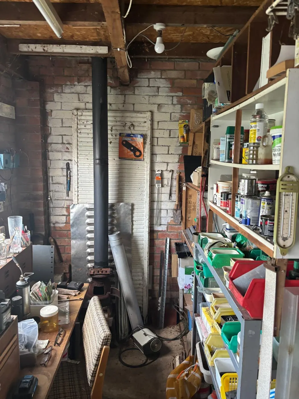 Brick garage workshop filled with tools and shelving before a garage clearance